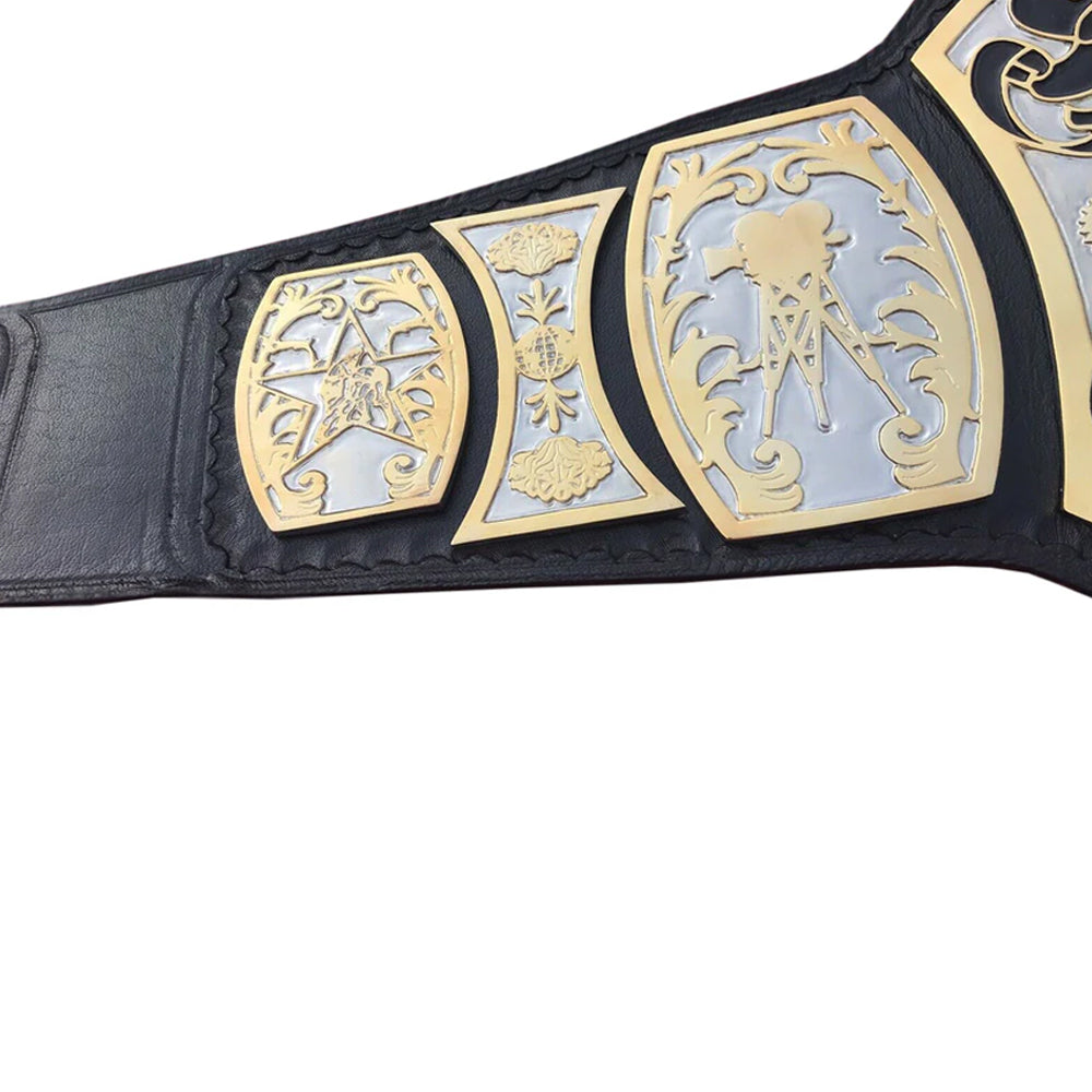 Close-up of UWF wrestling championship belt with detailed gold and silver plates on black leather